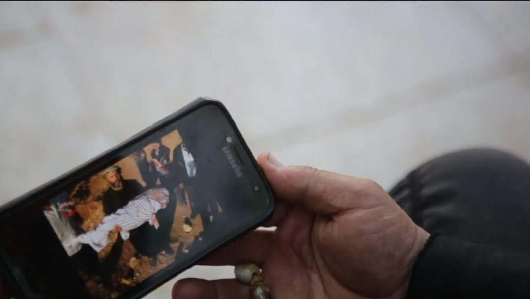 Father Ebu Izzet Hibbiye shows photos on his phone to an Anadolu Agency correspondent, al-Bab, Syria, March 7, 2022 (AA Photo)