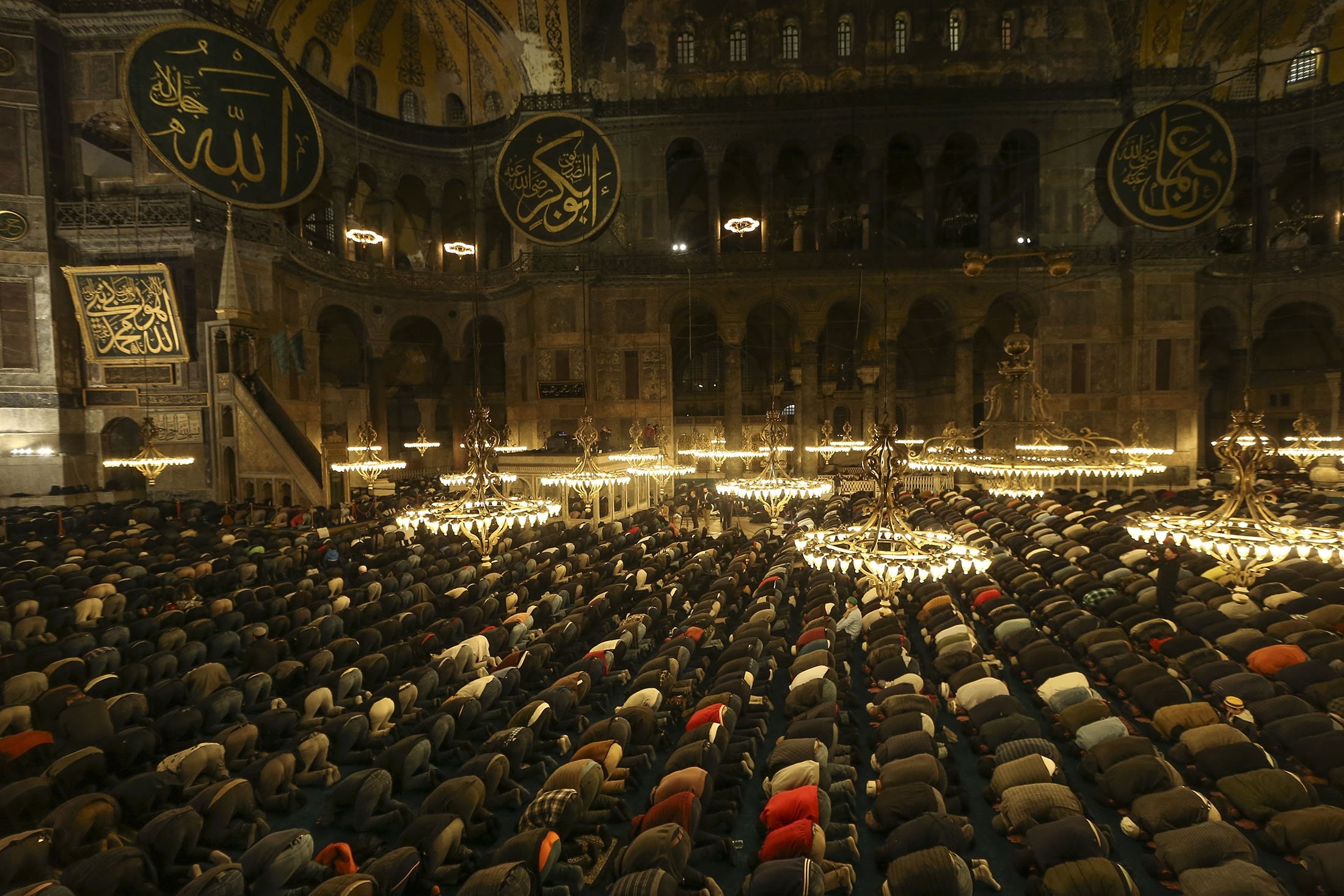 Muslim worshippers perform a night prayer called "tarawih" during the eve of the first day of the Muslim holy fasting month of Ramadan at Hagia Sophia Grand Mosque in Istanbul, Turkey, April 1, 2022. (AP Photo)