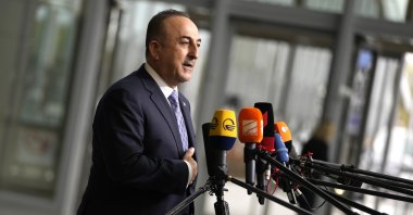 Foreign Minister Mevlüt Çavuşoğlu speaks with the media as he arrives for a meeting of NATO foreign ministers at NATO headquarters in Brussels, April 6, 2022. (AP Photo)