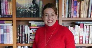 Julia Quinn, the author of the &quot;Bridgerton&quot; book series, poses at her home in Seattle, U.S, March 8, 2022. (AP Photo)