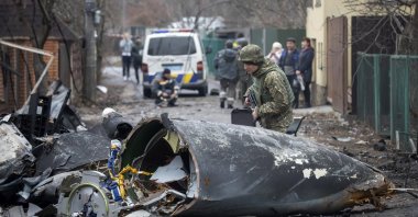 A Ukrainian soldier inspects fragments of a downed aircraft in Kyiv, Ukraine, Feb. 25, 2022.  (AP Photo)