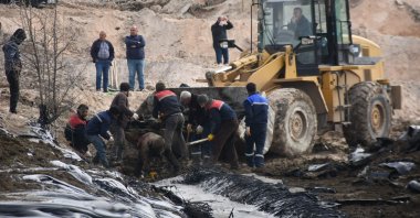 Efforts are underway to clean up tons of pitch spreading to farmlands following a leak at an asphalt construction site in Edirne, Turkey, April 7, 2022. (DHA PHOTO)