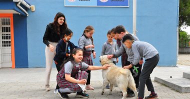 Teacher Elmas Tefçi and her students pose with Badem in the schoolyard, Manisa, Turkey, April 7, 2022. (DHA Photo)