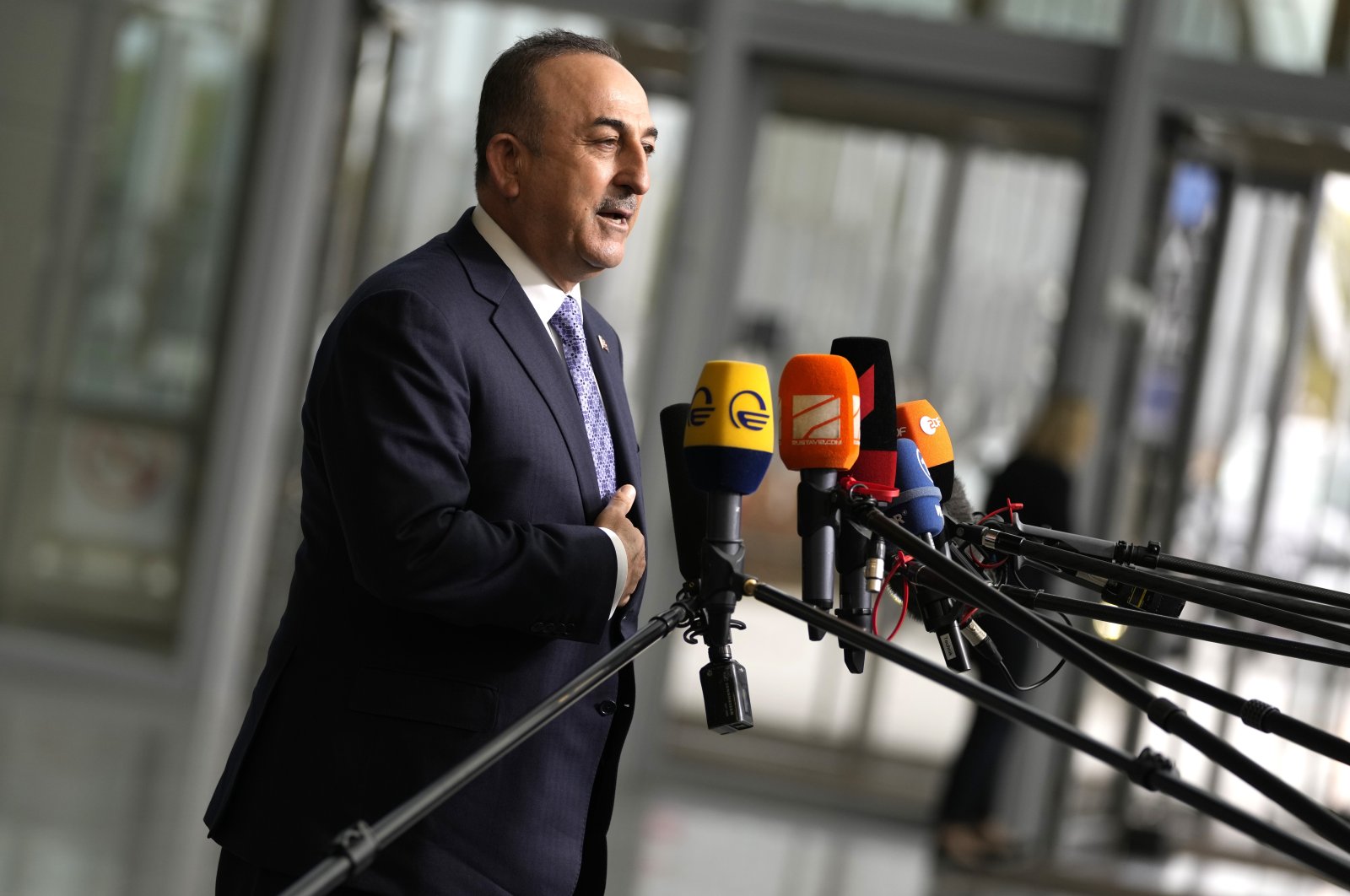 Foreign Minister Mevlüt Çavuşoğlu speaks with the media as he arrives for a meeting of NATO foreign ministers at NATO headquarters in Brussels, April 6, 2022. (AP Photo)