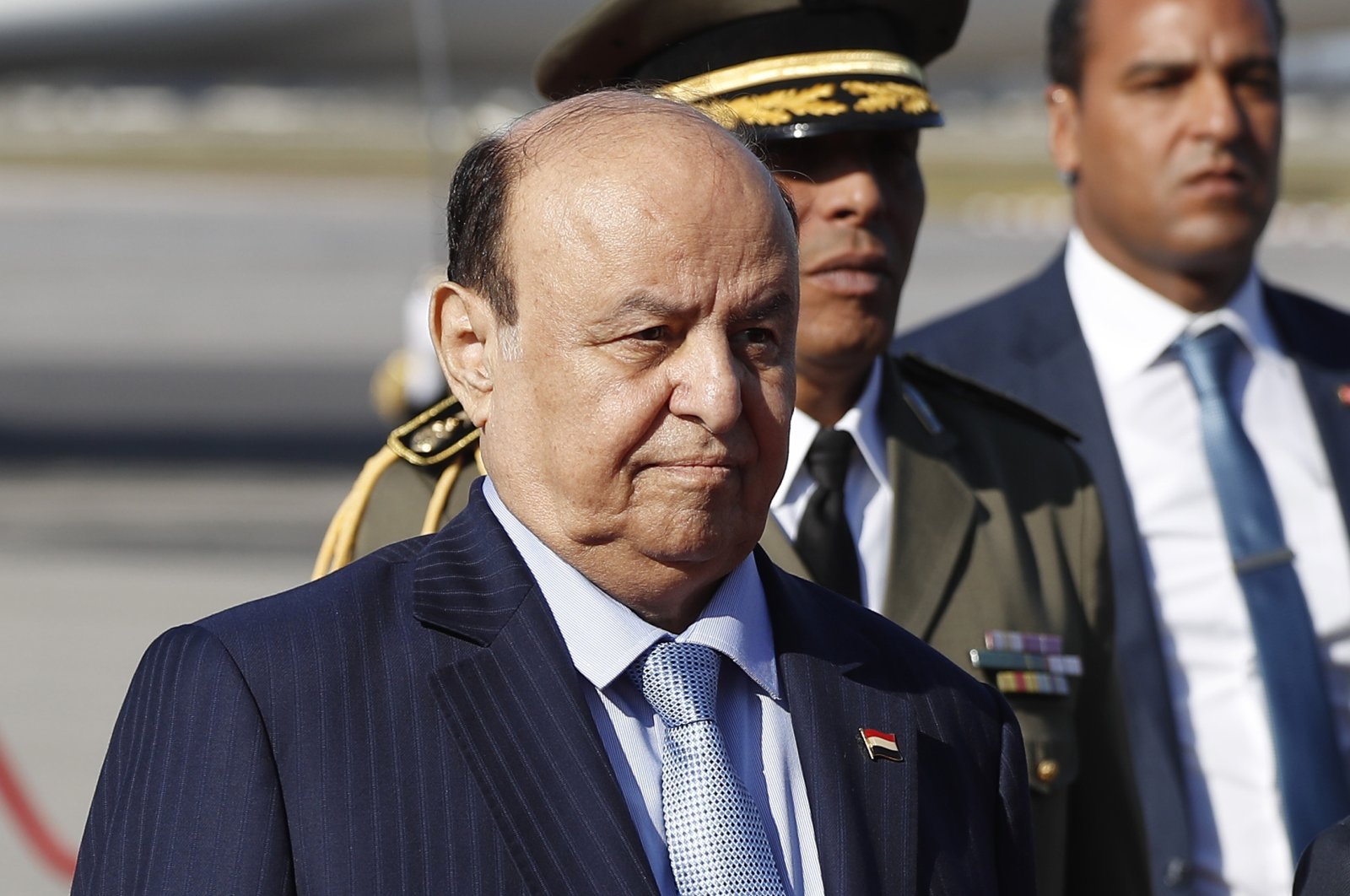 Yemen&#039;s President Abed Rabbo Mansour Hadi walks next of his Tunisian counterpart Beji Caid Essebsi, not in photo, upon his arrival at Tunis-Carthage international airport to attend the Arab Summit, in Tunis, Tunisia, March 30, 2019. (AP Photo)