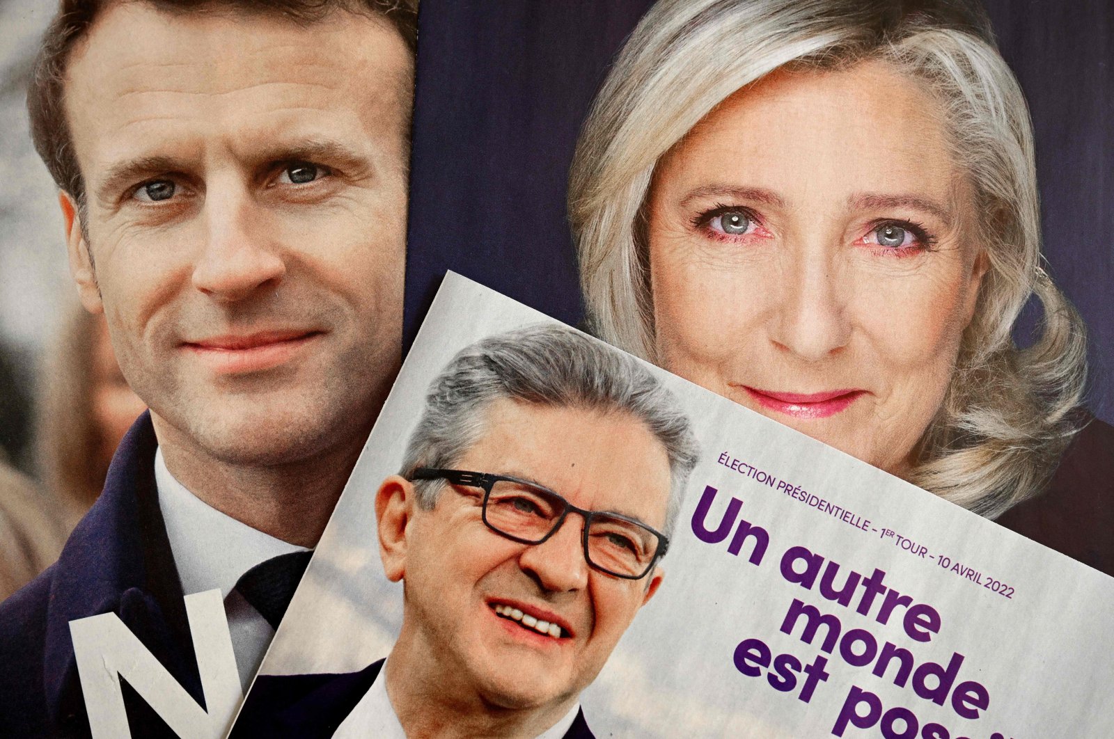 The folded electoral leaflets of French President Emmanuel Macron&#039;s La Republique en Marche party (L), La France Insoumise party&#039;s presidential candidate Jean-Luc Melenchon (C) and far-right Rassemblement National candidate Marine Le Pen ahead of the first round of the French presidential election, Marseille, southern France, April 6, 2022.