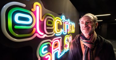 MOMEM director Alex Azary shows off a neon sign that responds to sounds. (DPA)