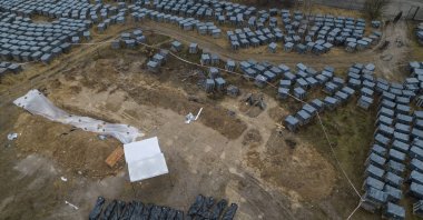 Plastic bags with corpses exhumed from a mass grave are lined up in Bucha, on the outskirts of Kyiv, Ukraine, April 8, 2022. (AP Photo)
