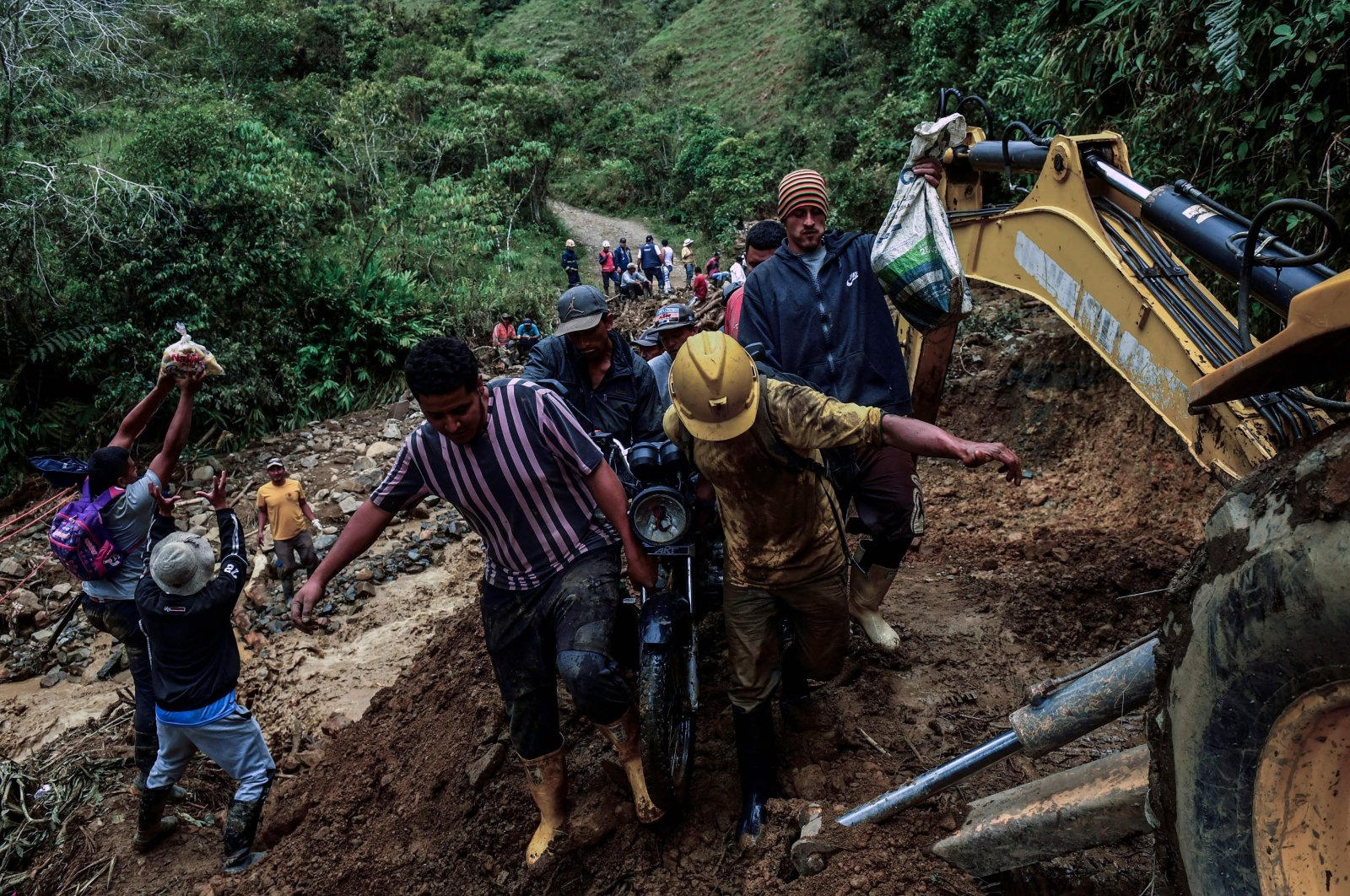 Miners exit the area near a gold mine affected by a landslide in Abriaqui, Antioquia department, Colombia, April 7, 2022. (AFP Photo)