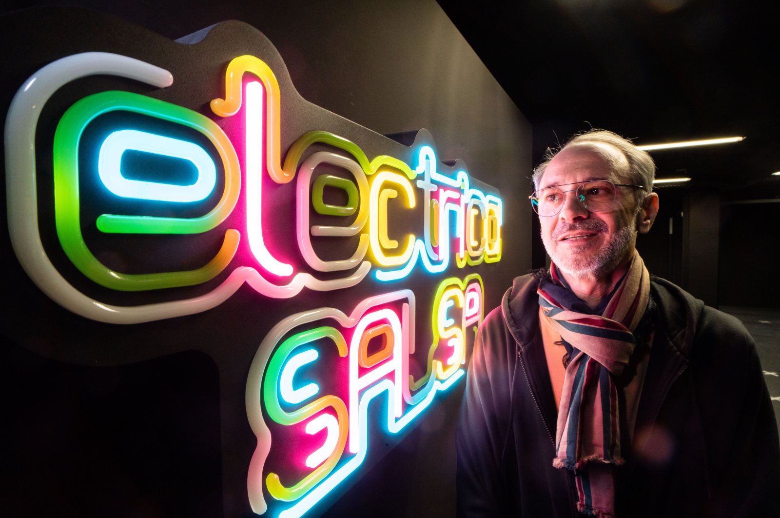 MOMEM director Alex Azary shows off a neon sign that responds to sounds. (DPA)