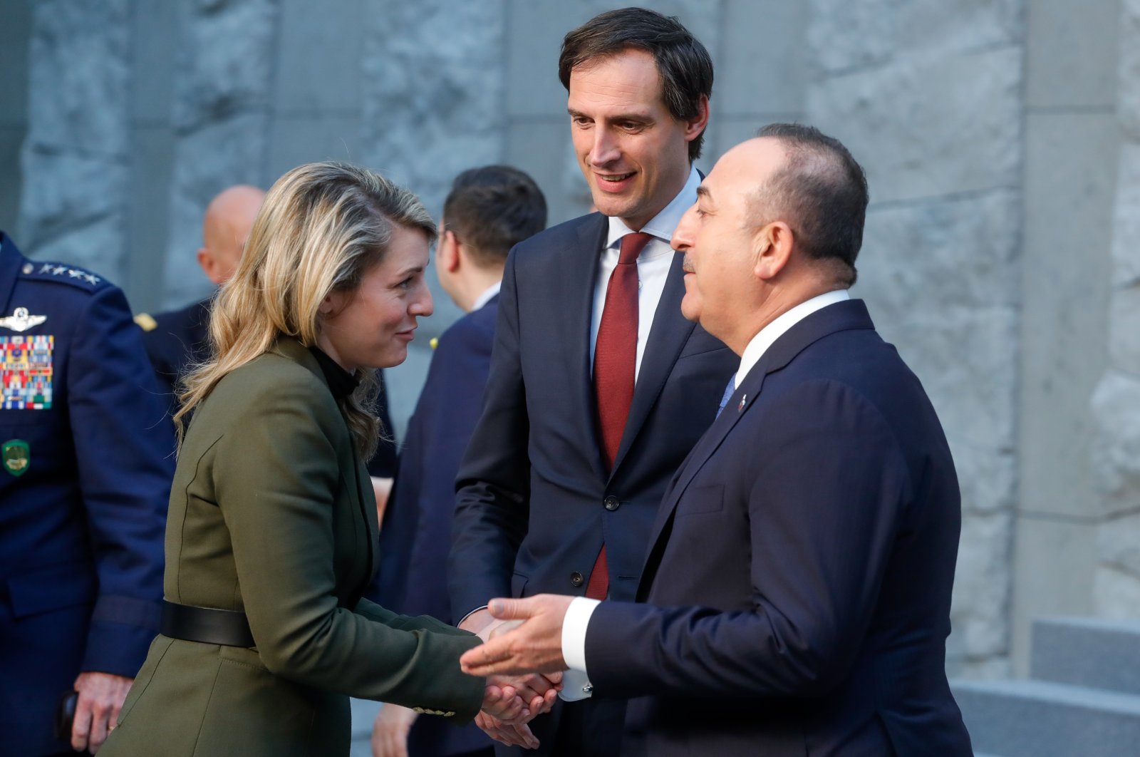 Canadian Foreign Minister Melanie Joly (L), Dutch Minister of Foreign Affairs Wopke Hoekstra (C) and Turkish Foreign Minister Mevlüt Çavuşoğlu (R) chat during a group photo session following a meeting of NATO foreign ministers at NATO headquarters in Brussels, Belgium, April 7, 2022. (EPA Photo)