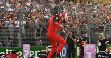 Ferrari's Monegasque driver Charles Leclerc comes out of his car to celebrate pole position in the qualifying session at the Albert Park Circuit in Melbourne, ahead of the 2022 Formula One Australian Grand Prix, April 9, 2022. (AFP Photo)