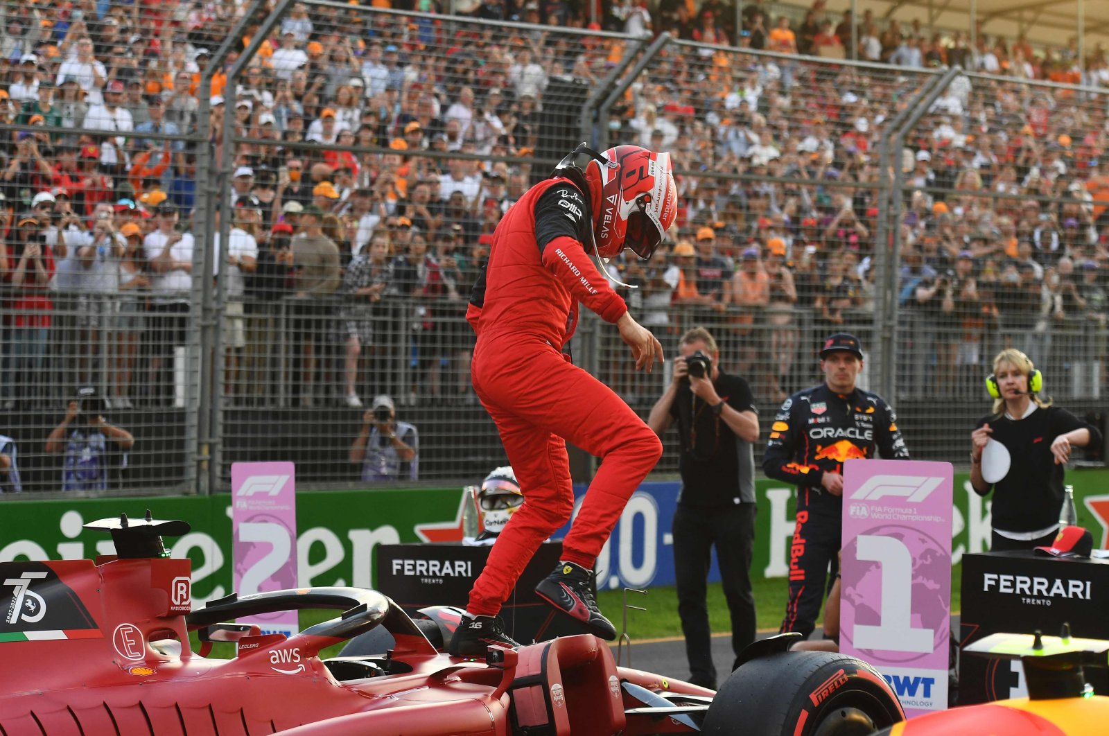 Ferrari&#039;s Monegasque driver Charles Leclerc comes out of his car to celebrate pole position in the qualifying session at the Albert Park Circuit in Melbourne, ahead of the 2022 Formula One Australian Grand Prix, April 9, 2022. (AFP Photo)