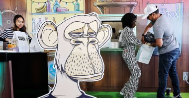 People gather at the grand opening of the Bored &amp; Hungry pop-up burger restaurant, which uses NFT art for its branding, in Long Beach, California, U.S., April 9, 2022. (AFP Photo)