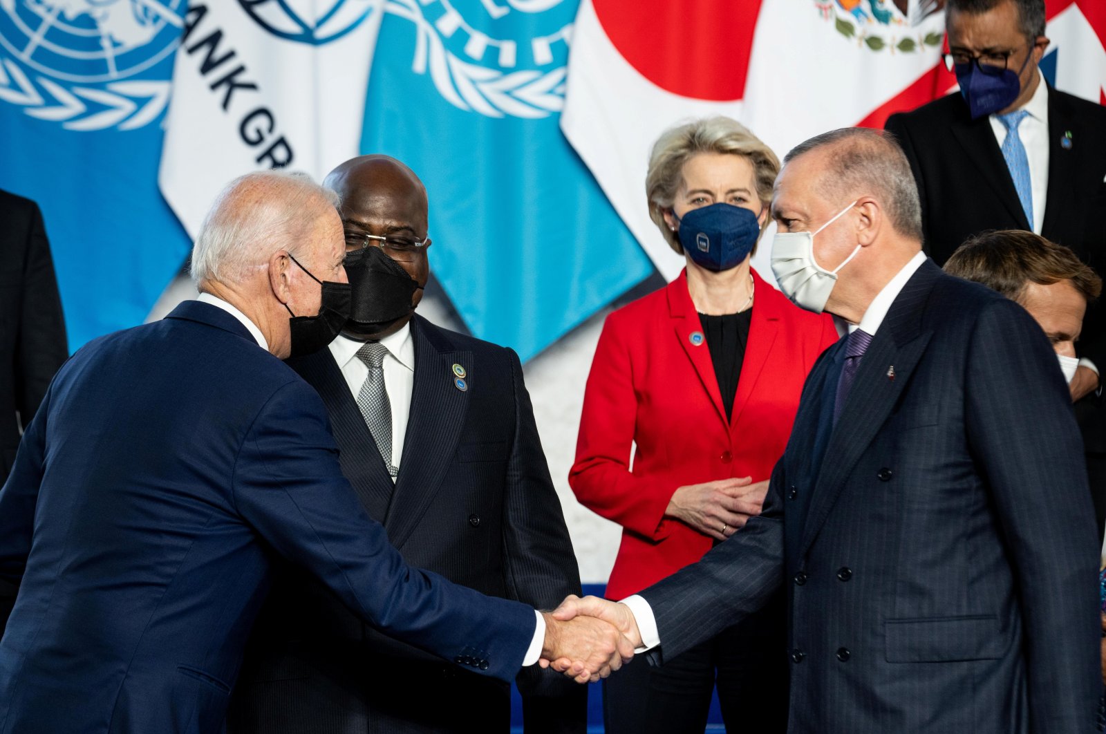 U.S. President Joe Biden (L) and President Recep Tayyip Erdoğan shake hands during the family photo at the G-20 summit in Rome, Italy, Oct. 30, 2021. (Reuters Photo)