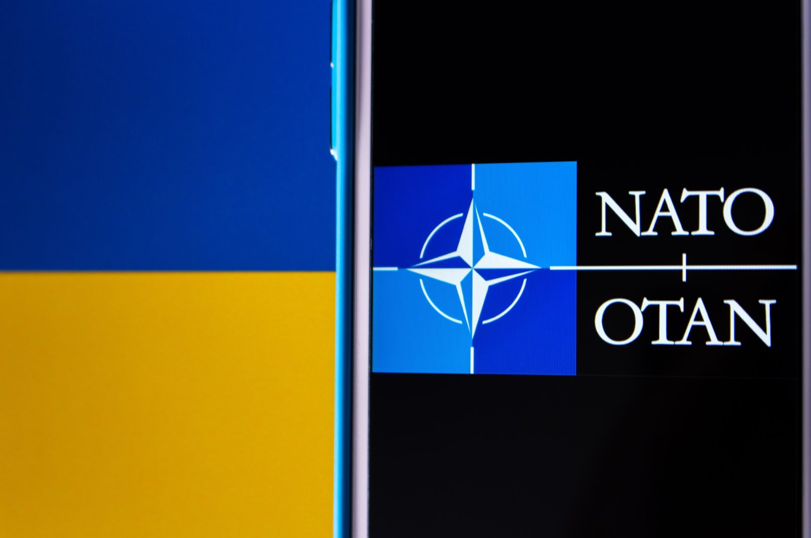 The logo of NATO is seen on the Ukraine flag in a photo taken in Kumamoto, Japan, March 1, 2022. (Photo by Shutterstock)