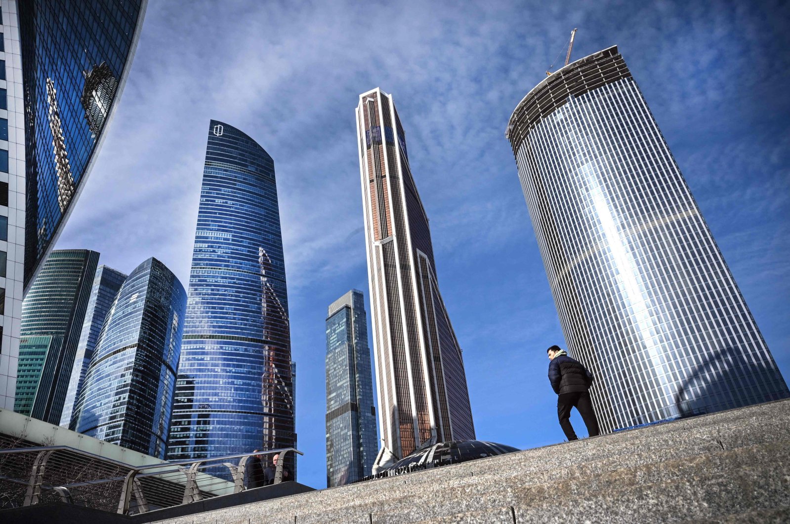 A man walks in front of the Moscow International Business Center (Moskva City) in Moscow, Russia, March 11, 2022. (AFP Photo)