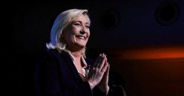 Marine Le Pen, leader of French far-right National Rally (Rassemblement National) party and candidate for the 2022 French presidential election, gestures as she appears on stage after partial results in the first round of the 2022 French presidential election are announced, in Paris, in Paris, France, April 10, 2022. (Reuters Photo)
