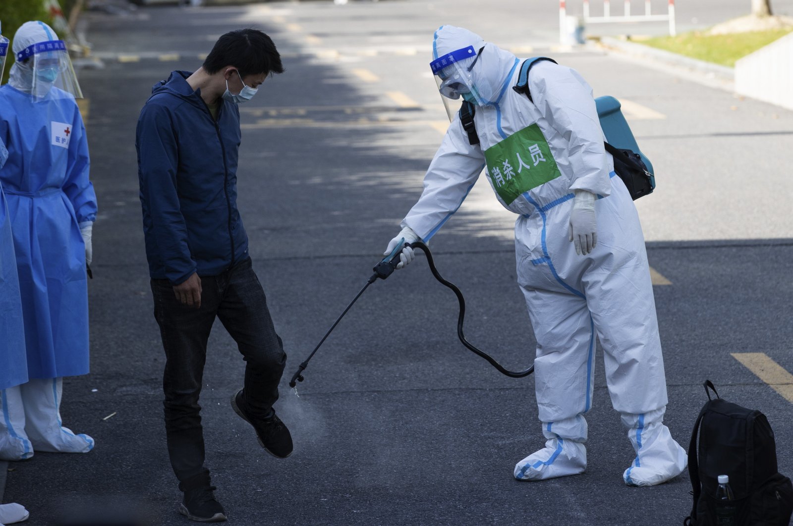 A patient who has recovered from COVID-19 is disinfected as he leaves a makeshift hospital converted from Shanghai Convention &amp; Exhibition Center of International Sourcing in Shanghai, April 9, 2022. (AP PHOTO)