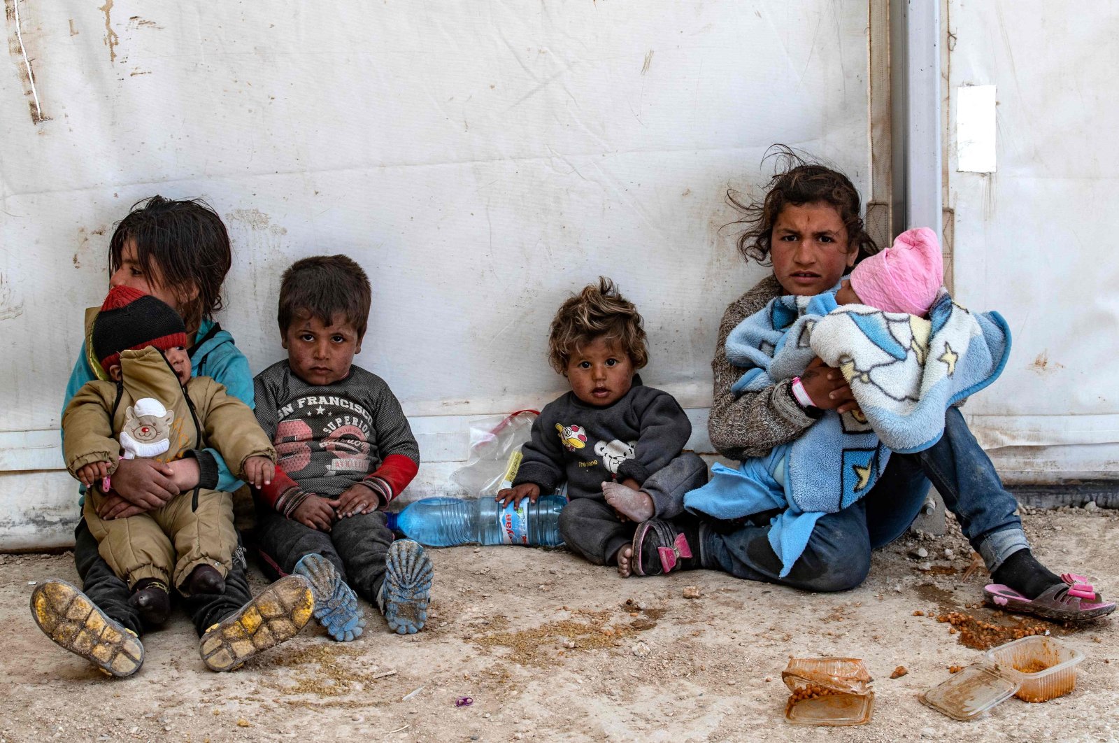 Syrian women and children sit at the al-Hol camp in the Hassakeh governorate of northeastern Syria, March 18, 2021. (AFP)