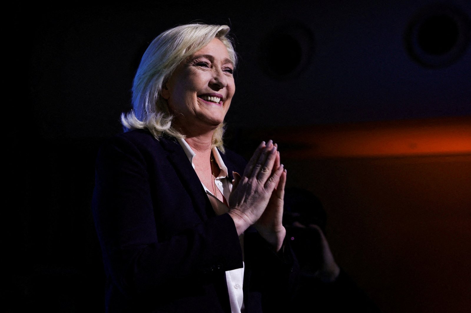 Marine Le Pen, leader of French far-right National Rally (Rassemblement National) party and candidate for the 2022 French presidential election, gestures as she appears on stage after partial results in the first round of the 2022 French presidential election are announced, in Paris, in Paris, France, April 10, 2022. (Reuters Photo)