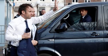 France's President Emmanuel Macron (L) arrives to meet with supporters during a one-day campaign visit in Carvin, France, April 11, 2022. (AFP Photo)