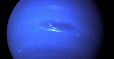 The "Great Dark Spot," a storm in the atmosphere and the bright, light-blue smudge of clouds that accompanies the storm is seen on the planet Neptune, taken by the NASA spacecraft Voyager 2, Aug. 25, 1989. (NASA via Reuters)