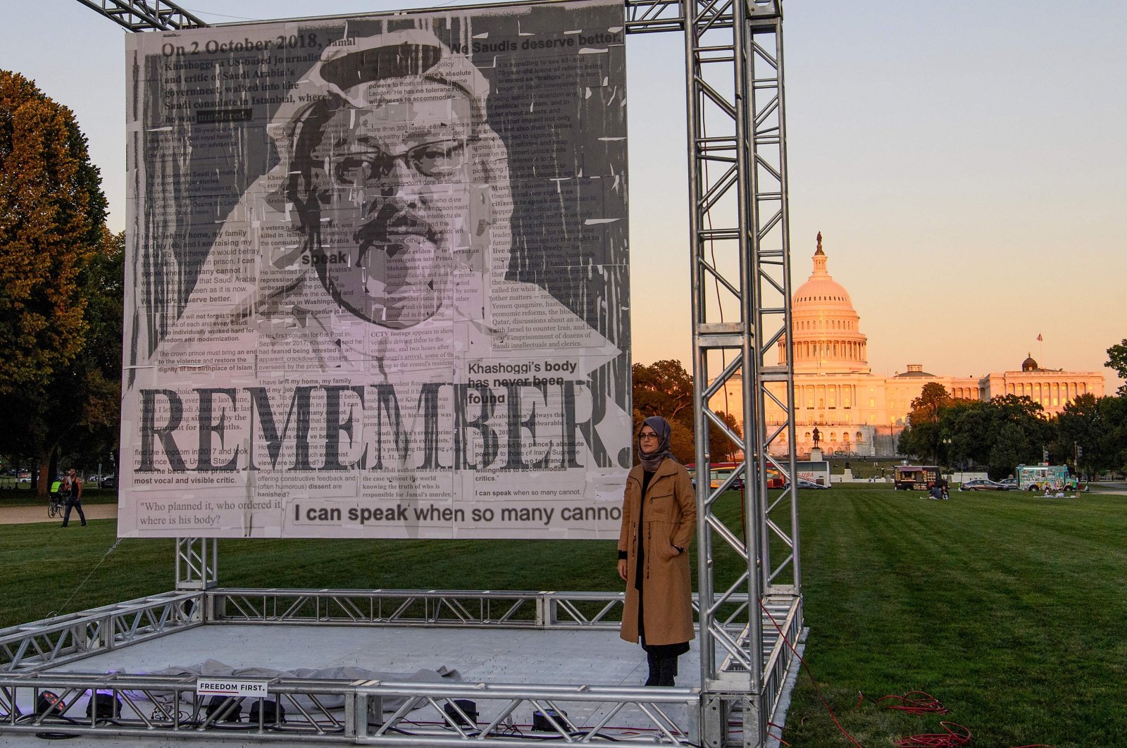 Hatice Cengiz (R), the fiancee of Saudi journalist Jamal Khashoggi, posing next to a portrait of Khashoggi after unveiling it on the National Mall in Washington, D.C., U.S., Oct. 2, 2021. (AFP Photo)