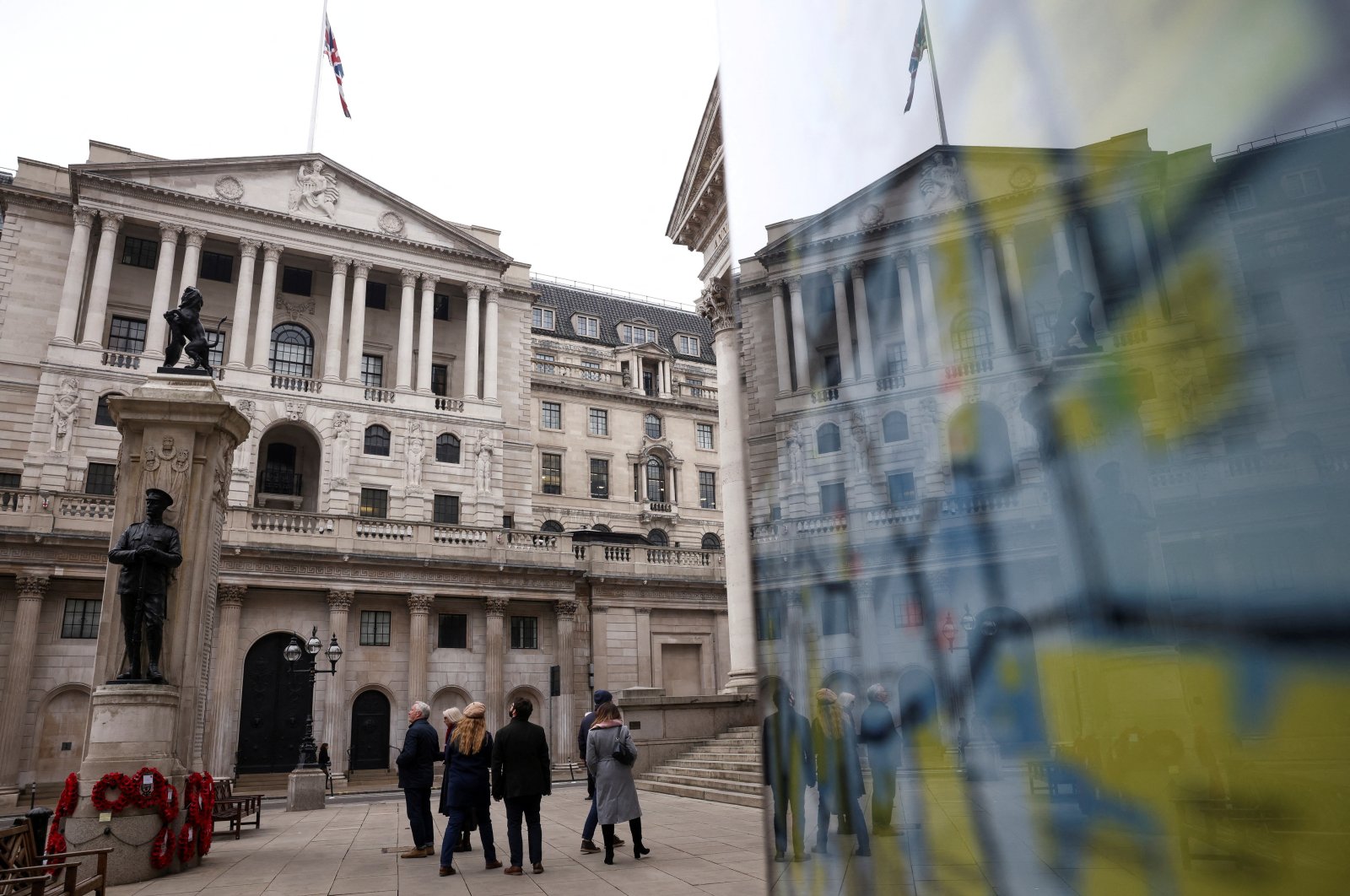 People stand outside the Bank of England (BoE) in the City of London financial district in London, Britain, Jan. 23, 2022. (Reuters Photo)