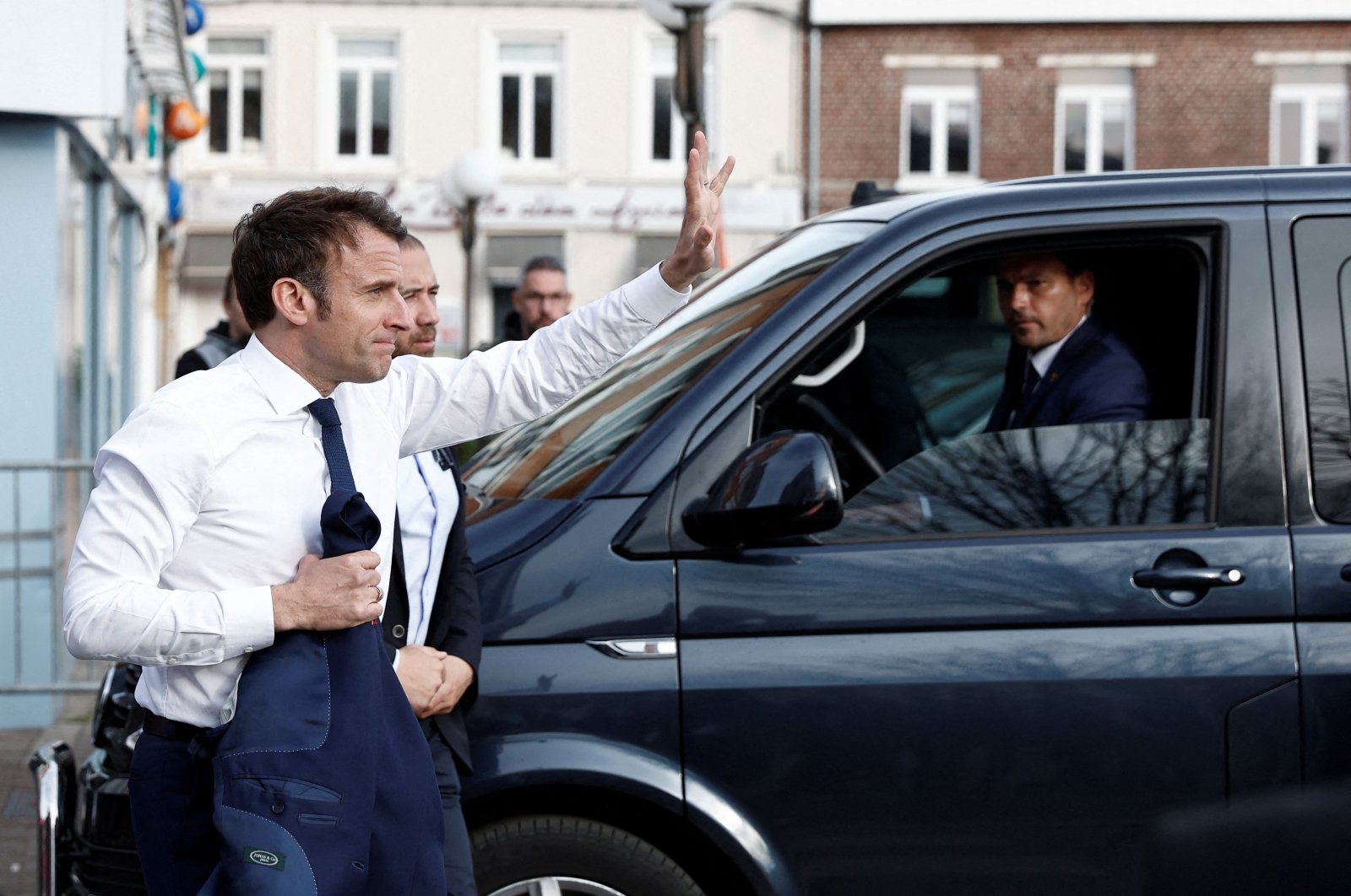 France&#039;s President Emmanuel Macron (L) arrives to meet with supporters during a one-day campaign visit in Carvin, France, April 11, 2022. (AFP Photo)
