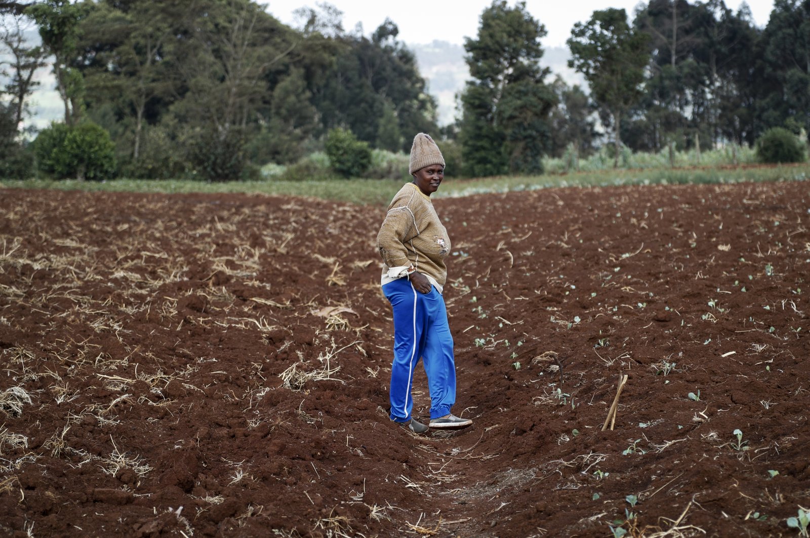 Farmer Monicah Wanjiku walks around her farm in Kiambu, near Nairobi, in Kenya, March 31, 2022. (AP Photo)