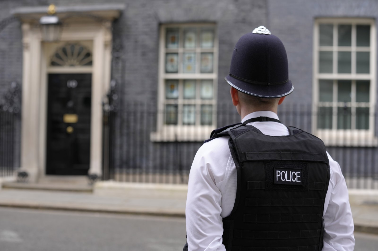A police officer stands opposite the door of 10 Downing Street in London, Tuesday, April 12, 2022. U.K. Prime Minister Boris Johnson's office says he will be issued a fine for breaching COVID-19 regulations following allegations of lockdown parties at government offices. Treasury Chief Rishi Sunak will also be fined. (AP Photo/Kirsty Wigglesworth)