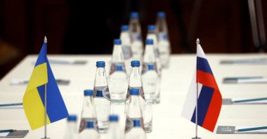 Russian and Ukrainian flags are seen on a table before the talks between officials of the two countries in the Gomel region, Belarus Feb. 28, 2022.  (BelTA/Handout via Reuters)