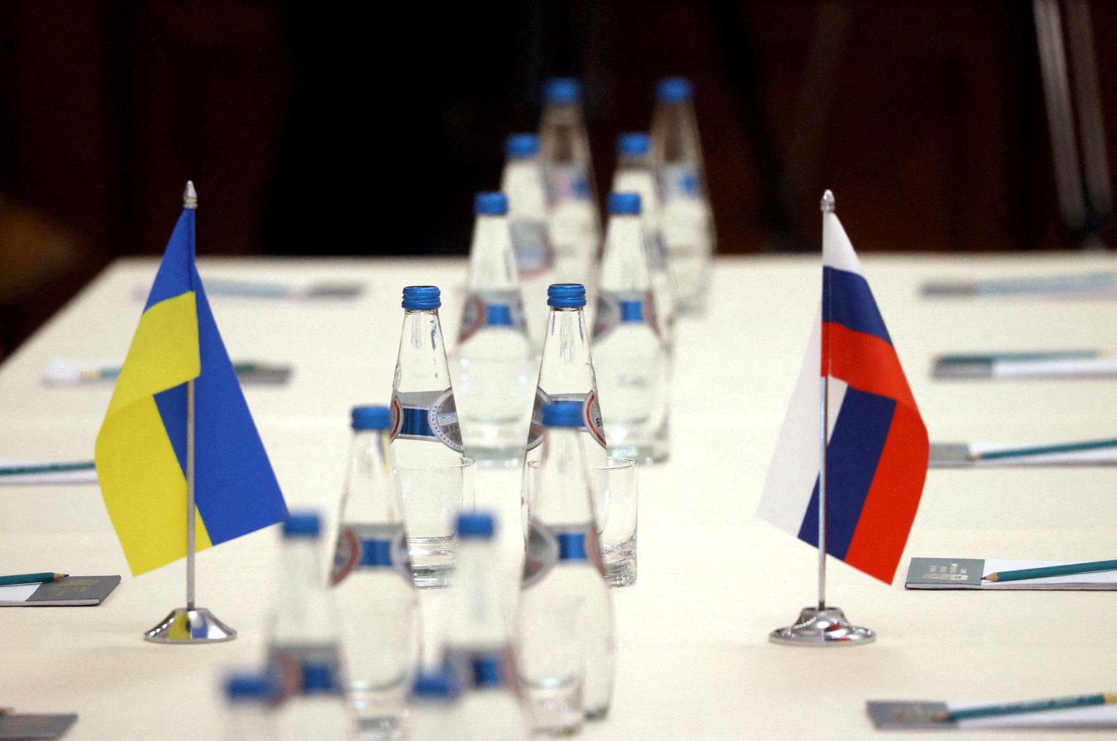 Russian and Ukrainian flags are seen on a table before the talks between officials of the two countries in the Gomel region, Belarus Feb. 28, 2022.  (BelTA/Handout via Reuters)
