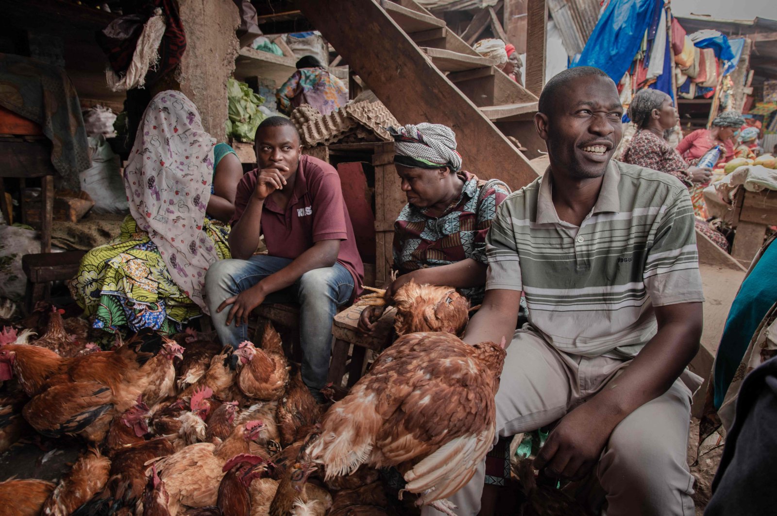 Vendors selling chickens talk to their customers in the Nyawera market in Bukavu, eastern Democratic Republic of Congo, March 16, 2022. (AFP Photo)