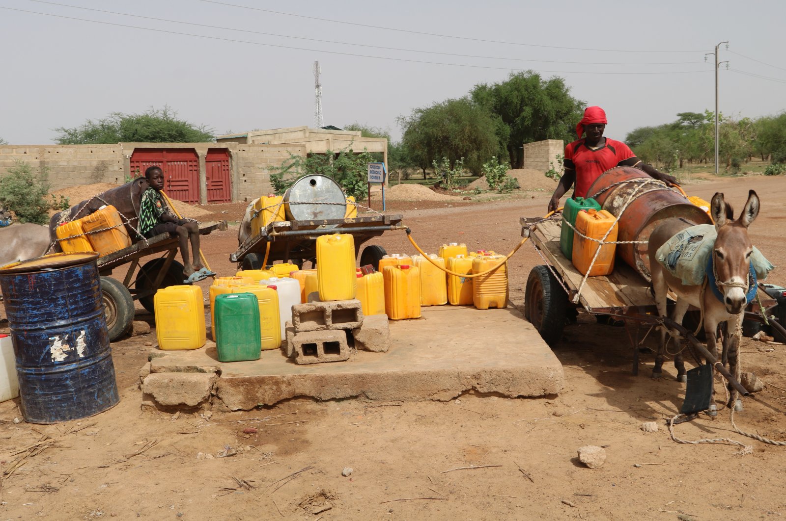 Residents fill up water containers in Dori, Burkina Faso, July 7, 2021. (AP Photo)