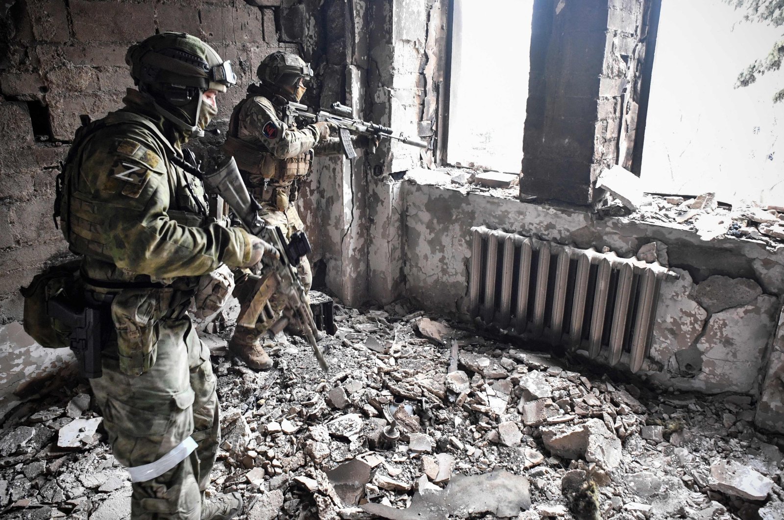 Two Russian soldiers patrol in the Mariupol drama theatre bombed last March 16, Mariupol, Ukraine, April 12, 2022, (AFP Photo)