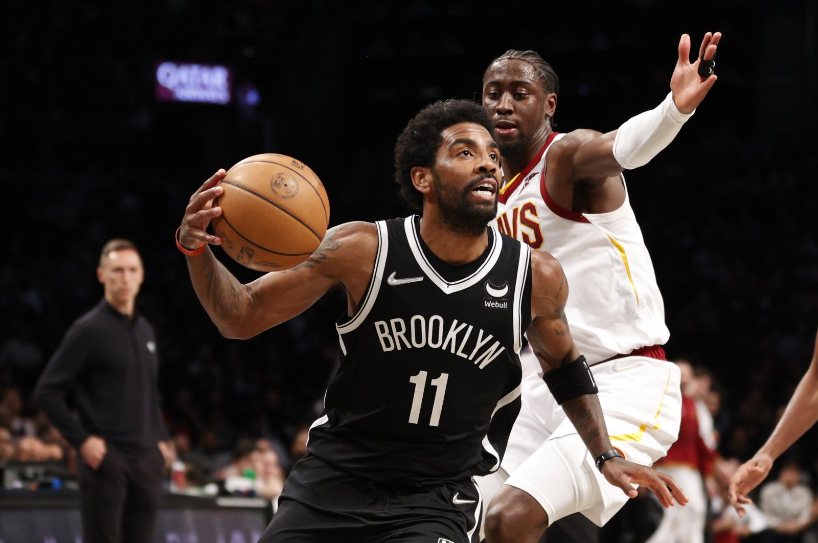 Brooklyn Nets&#039; Kyrie Irving (L) dribbles past Cavaliers&#039; Caris LeVert in an NBA game, New York City, U.S., April 12, 2022. (AFP Photo)