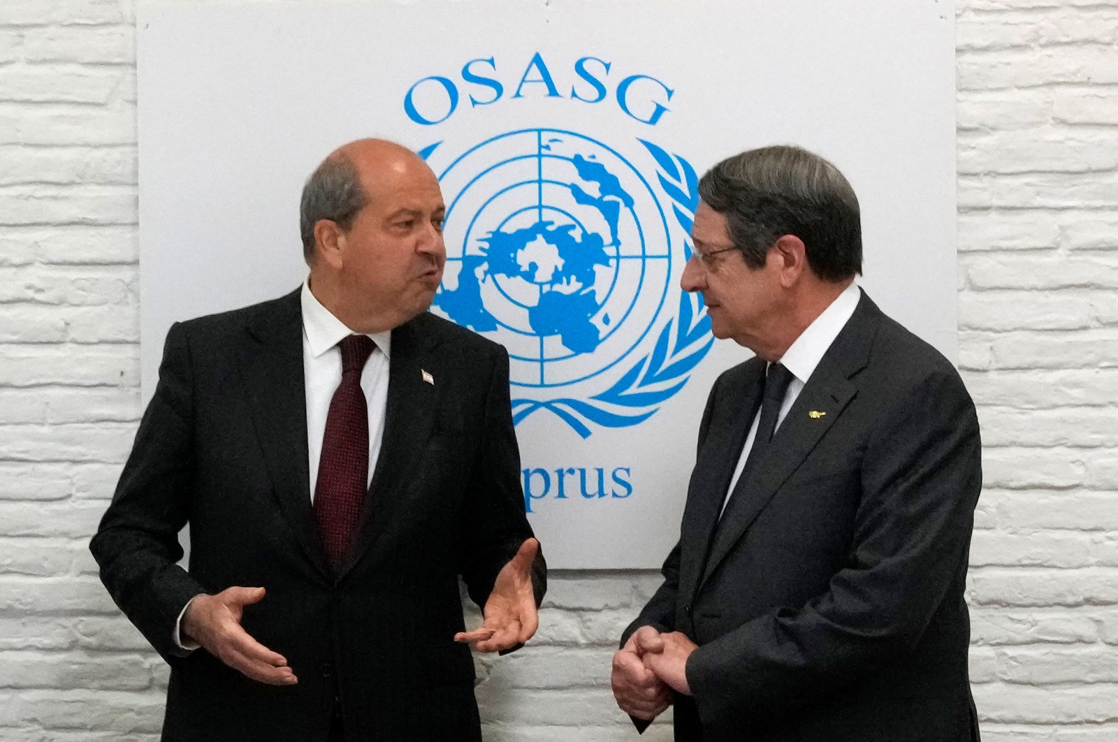 Turkish Cypriot President Ersin Tatar (L) and Greek Cypriot leader Nicos Anastasiades meet at an event hosted by the United Nations in the buffer zone area, in Lefkoşa (Nicosia), Cyprus Island, April 13, 2022. (Reuters Photo)