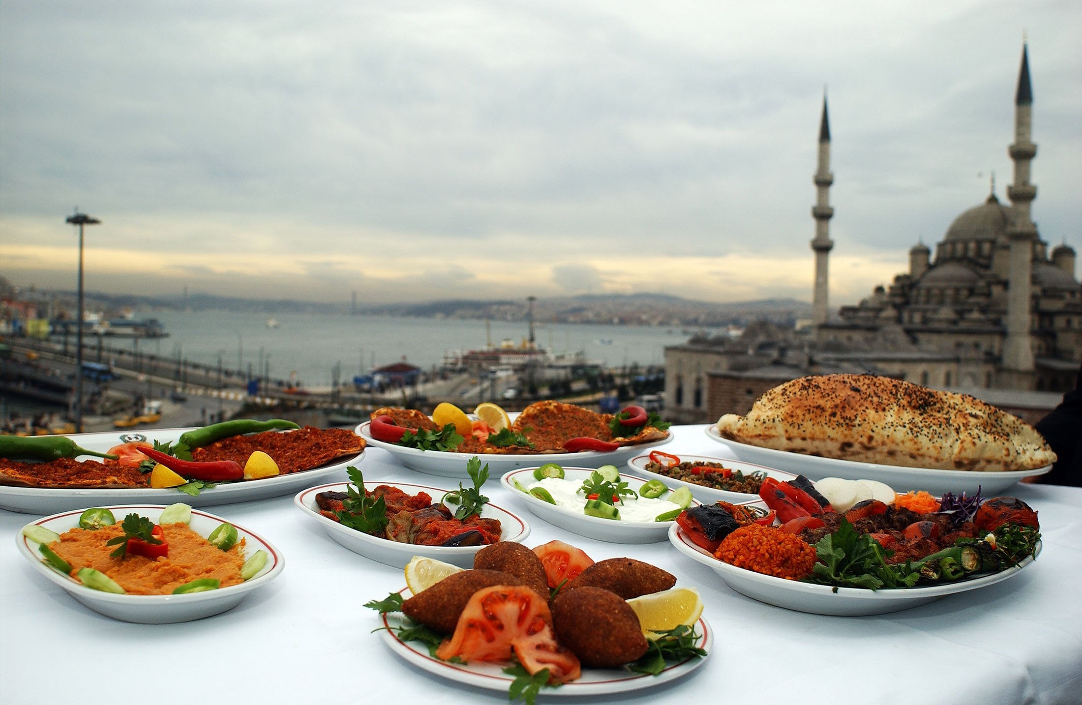 Turkish dishes can be seen with the New Mosque in the background, in Istanbul, Turkey, May 24, 2006. (Shutterstock Photo)