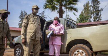 Paul Rusesabagina, whose story inspired the film &quot;Hotel Rwanda,&quot; wears a pink prison uniform as he arrives for a bail hearing at a court in the capital Kigali, Rwanda on Sept. 25, 2020. (AP Photo)