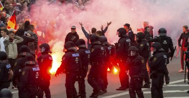 In this Aug. 27, 2018 photo, protesters light fireworks during a far-right demonstration in Chemnitz, Germany.