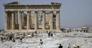 Visitors walk in front of the Parthenon Temple in Athens, Greece, April 6, 2022. (AFP Photo)