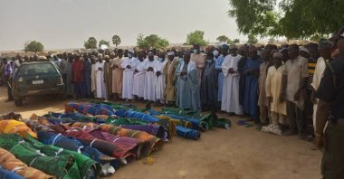 People gather around the victims&#039; bodies, which were recovered after a boat capsized in Sokoto, during a prayer before their burial in Nigeria, April 13, 2022. (Reuters Photo)