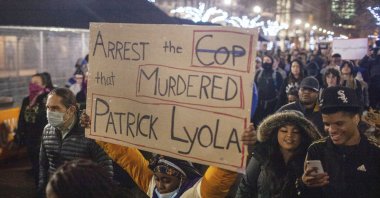 Protesters march through downtown Grand Rapids, Mich., near the police department during a demonstration held after videos of the shooting of Patrick Lyoya, by a Grand Rapids police officer on April 4, were released to the public, April 13, 2020. (Daniel Shular/The Grand Rapids Press via AP)