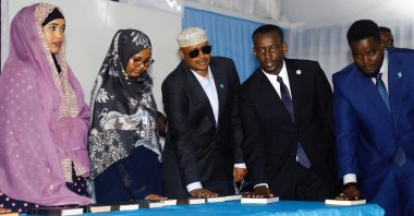 Somalia&#039;s newly elected lawmakers place their hands on copies of the holy Quran as they are sworn in at the Afisyoni election hall in Mogadishu, Somalia, April 14, 2022. (REUTERS Photo)