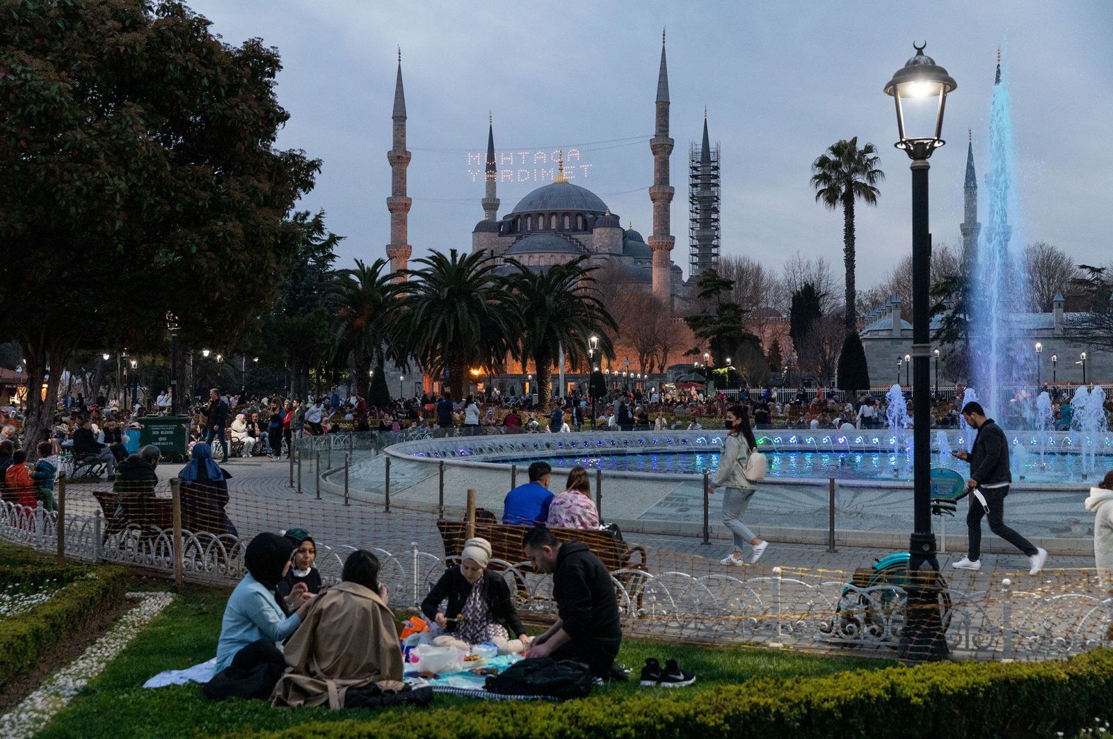 Muslims break their fast as part of iftar, in Sultanahmet Square during Ramadan, in Istanbul, Turkey, April 10, 2022. (Shutterstock Photo)