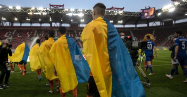 Shakhtar Donetsk players enter the pitch ahead of a friendly match against Olympiakos, Athens, Greece, April 9, 2022. (AP Photo)