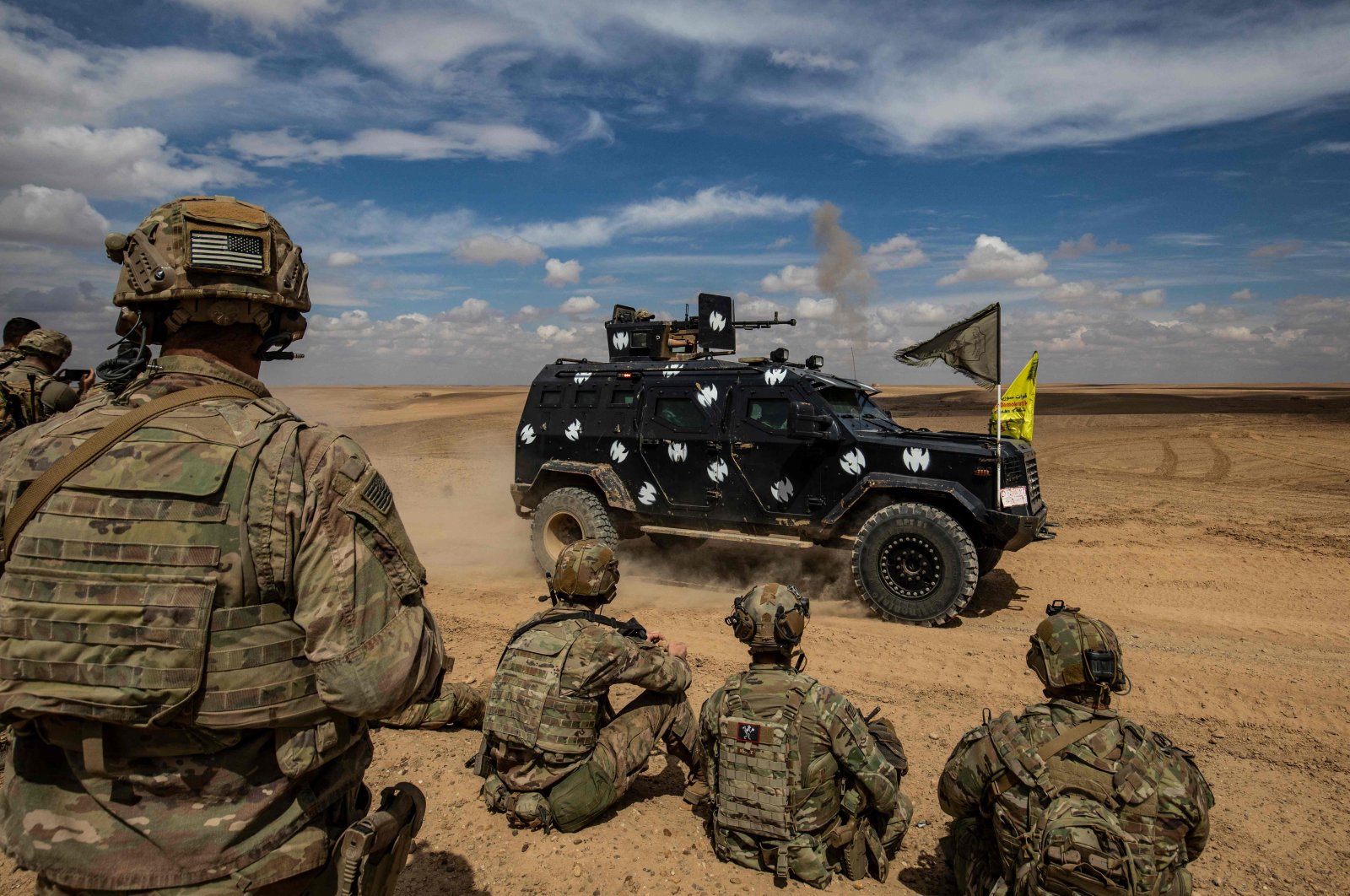 YPG forces and the U.S.-led coalition troops jointly take part in heavy-weaponry military exercises in the countryside of Deir el-Zour, northeastern Syria, March 25, 2022. (AFP)