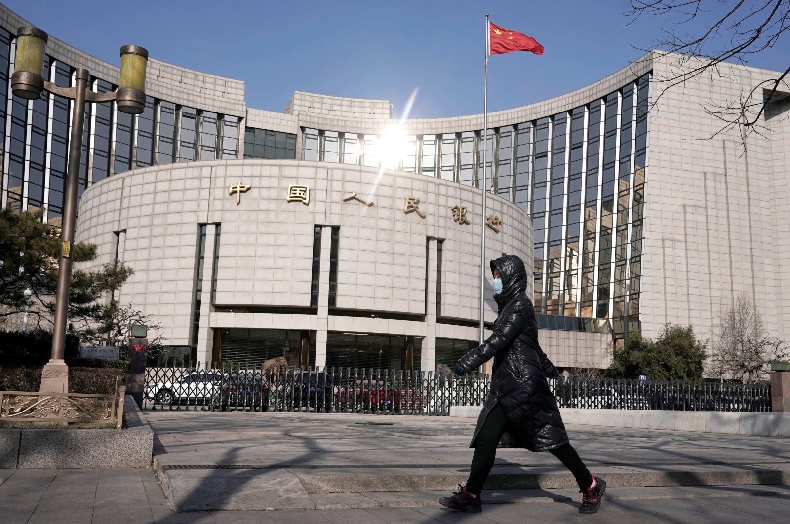 A woman walks past the headquarters of the People&#039;s Bank of China, the central bank, in Beijing, China, Feb. 3, 2020. (Reuters Photo)